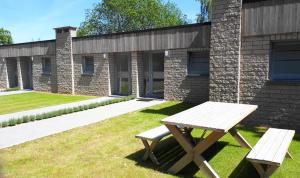 a picnic table and bench in front of a brick building at Terrasses de Malmedy F&L triplex 214 et studio 320 et 317 et Studio supérieur 340 in Malmedy