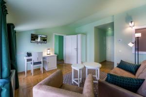 a living room with a couch and a table at Hotel Domino in Opatija