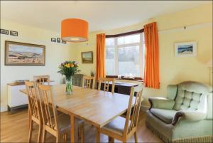 a dining room with a wooden table and chairs at Chy-an-Lowena in Crantock