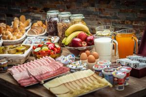 a table topped with lots of different types of food at Apartmány Jánošík in Terchová