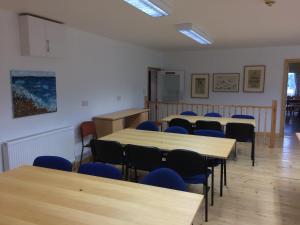 a classroom with tables and chairs in a room at YHA Isle of Wight Totland - Partner in Totland