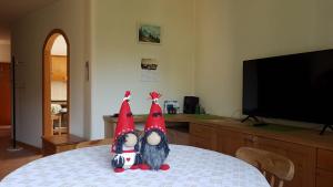 two stuffed animals sitting on top of a table at Alisea Home in Pinzolo