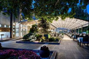 a restaurant with a tree in the middle of a building at Romantique Veles Hotel in Veles