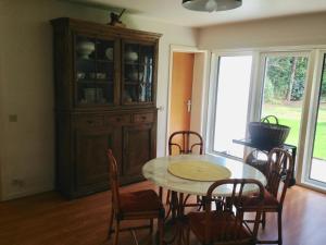 a dining room with a table and a hutch at B+B GOLF SCHILDE in Schilde
