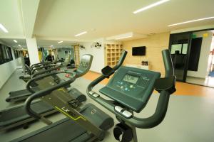a gym with a row of treadmills at Conforto E Localizacao in Salvador