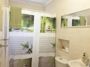 a bathroom with a shower and a toilet and a sink at SXM Spotters Paradise in Lowlands +37 photos