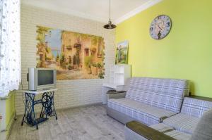 a living room with a couch and a tv at Rest Home in Sumy