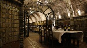 a dining room with a table in a wine cellar at Hotel Vinícola Real-200 Monges in Albelda de Iregua