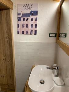 a bathroom with a sink and a sign on the wall at Guest House In Contrà in Lusiana