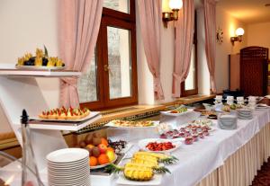 a buffet line with many plates of food on it at Hotel Ambiente Wellness & Spa in Karlovy Vary