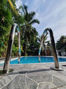 a pool with a water slide at a resort at Mihin Villa in Bentota