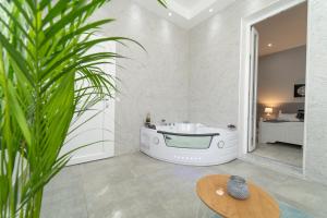 een badkamer met een bad en een wastafel bij Casa Solmes Rooms in Olbia