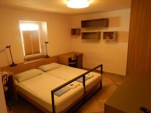 a small bedroom with a bed and a window at Casa Riccobon 5 in Koper