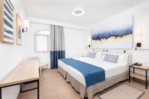 a hotel room with a bed and a desk at HD Parque Cristobal Tenerife in Playa de las Americas