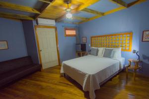 Postel nebo postele na pokoji v ubytování Hotel Hacienda Don Paolo