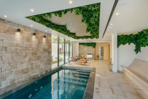 a house with a swimming pool and a living room at Boutique Hotel Casa del Mare - Vizura in Kotor