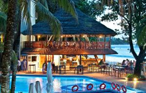 a resort with a swimming pool and a restaurant at Coral Strand Smart Choice in Beau Vallon