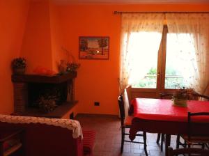 a dining room with a red table and a window at Piane Del Bagno in Saturnia