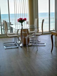 un comedor con mesa y sillas y el océano en Le Splendid, en La Baule