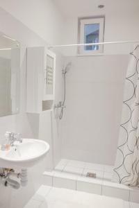 a white bathroom with a sink and a shower at József krt 3BR - near Corvin in Budapest