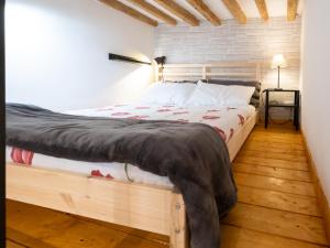 una camera con un grande letto con struttura in legno di Il nido - Cozy studio apartment in Santa Croce a Firenze