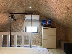 a bedroom with a bed and a tv in a attic at House 41 in Vila Nova de Famalicão