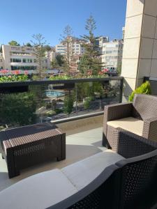 a patio with two chairs and a table on a balcony at Ramallah Modern Apartment in Ramallah