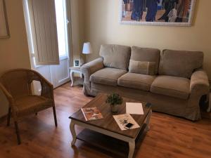 a living room filled with furniture and a couch at Life Apartments San Vicente in Seville