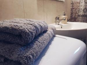 a bathroom with a toilet and a sink and towels at Nanaapartments in Perea +56 photos
