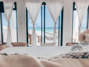 a bedroom with a bed and a view of the ocean at Icaco Island Village - Adults Only in Isla Mujeres