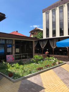 a building with a garden in front of it at Guest House Panorama in Adler