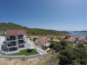 an aerial view of a house on a hill next to the water at VisitAylinVis in Vis