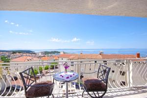 Makarska sea view rooms في ماكارسكا: بلكونه فيها كرسيين وطاولة مطلة
