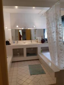 een badkamer met een wastafel en een grote spiegel bij Superb architect villa 230m2 near beach south France in Salses-le-Chateau