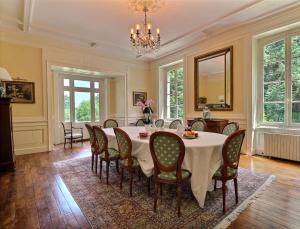 a dining room with a table and chairs at Manoir Les Brieux in Plélan-le-Grand