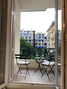 a balcony with two chairs and a table on a balcony at chez Eva in Nice