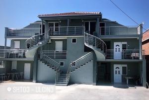 a building with stairs on the side of it at Apartments Beho in Ulcinj