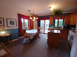 a kitchen with a table and chairs in a room at 3 Bedrooms 3 beds near metro -2 Parking Free in Montréal