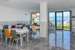 a dining room with a white table and chairs at Erpey Ferah Apart Otel in Balıkesir