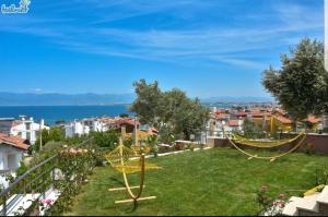 a garden with two hammocks in a yard at Erpey Ferah Apart Otel in Balıkesir