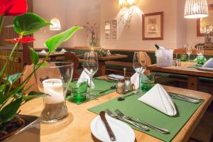 a table in a restaurant with a green table set up at Hotel Försterhof lebe pur, genieße den Tag in St. Wolfgang