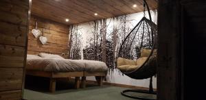 
a living room with a bed, chair, and a painting on the wall at Chalet Dcb in Bormio
