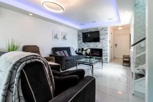 a living room with a couch and a fireplace at Fantastic Mission Beach condo steps to the Beach in San Diego