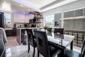 a kitchen and dining room with a table and chairs at Fantastic Mission Beach condo steps to the Beach in San Diego
