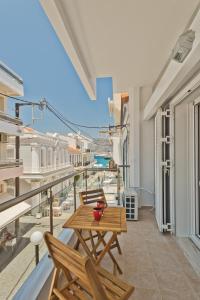 a balcony with a table and chairs and a view at Captain Elias Apartment 1 in Karpathos Town
