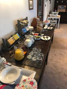 a long table filled with plates and bowls of food at Lane Head Farm Country Guest House in Troutbeck