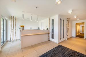 a living room with white walls and a counter at Apartmenthaus Am Park in Prerow