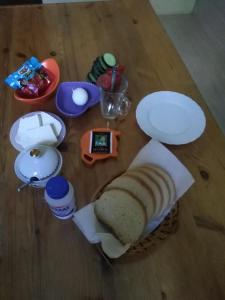 a table with a sandwich and other items on it at Why Me Eco-friendly Rooms in Tbilisi City