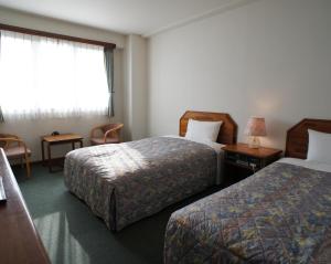 Tempat tidur dalam kamar di Hotel Sentpia