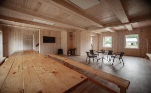 a large wooden room with a table and chairs at Guest house Elernes Muiža in Daugavpils